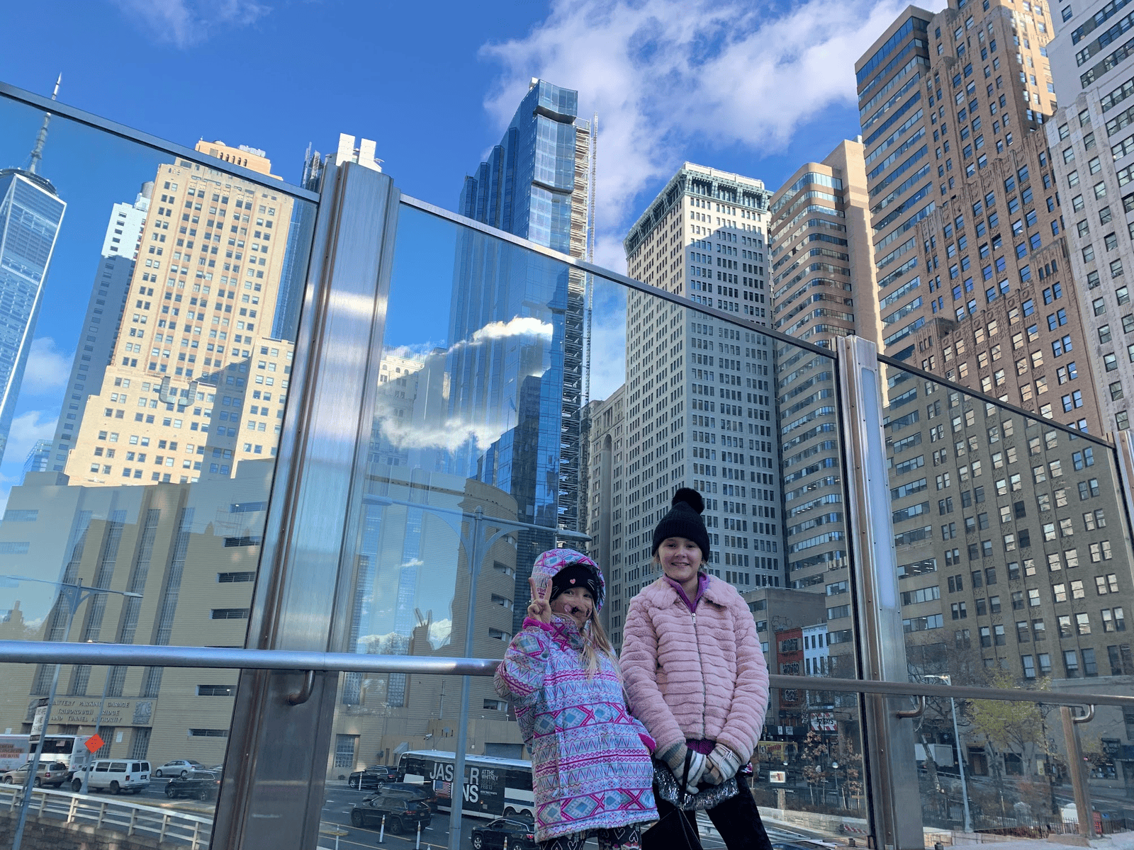 two girls with NYC skyline behind them