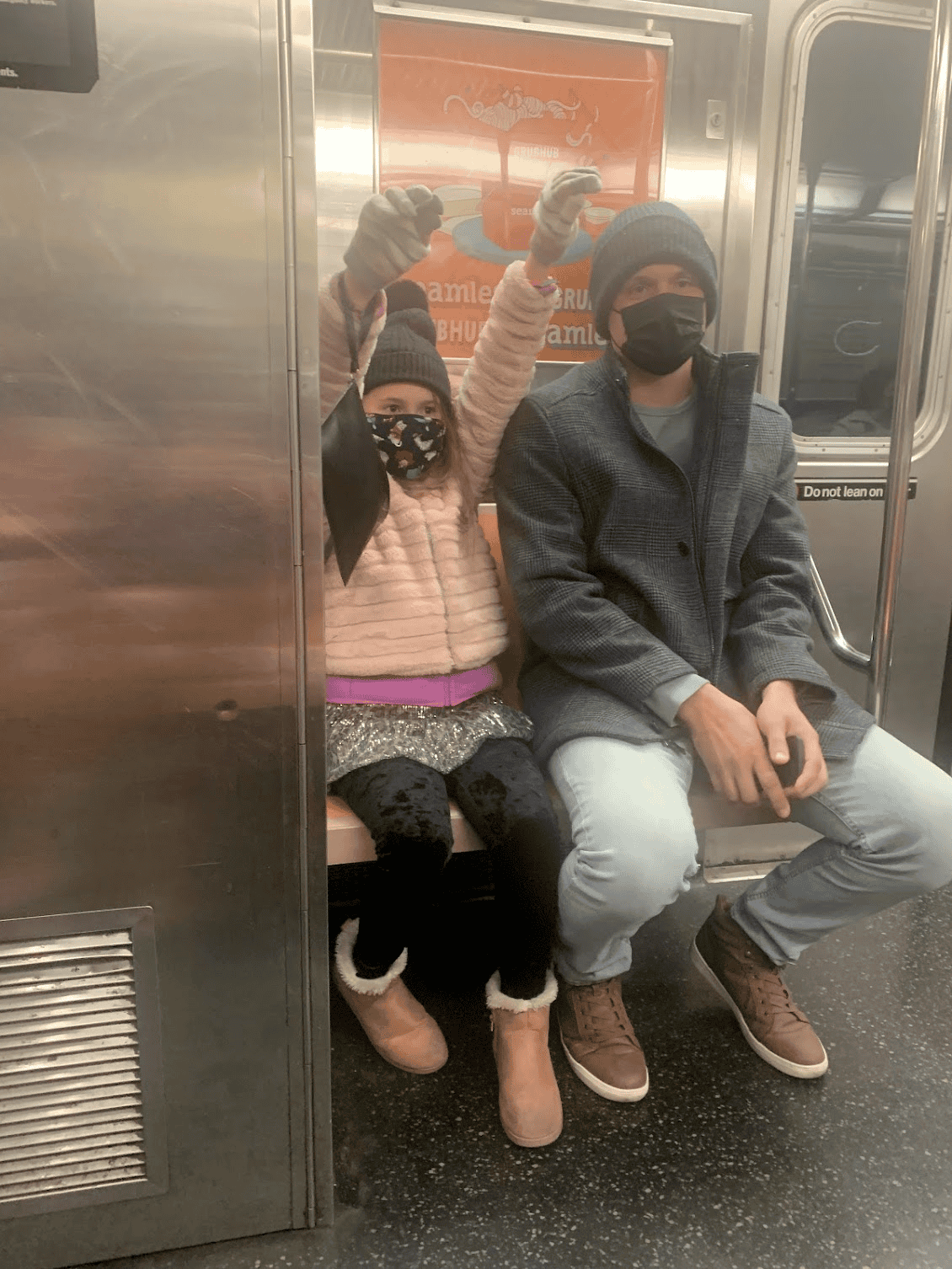 dad and daughter riding on Subway